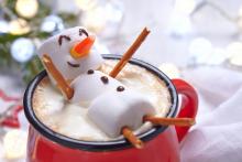 snowman made out of marshmellows in a mug of hot chocolate