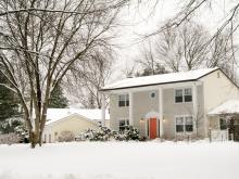 colonial house exterior during winter snow