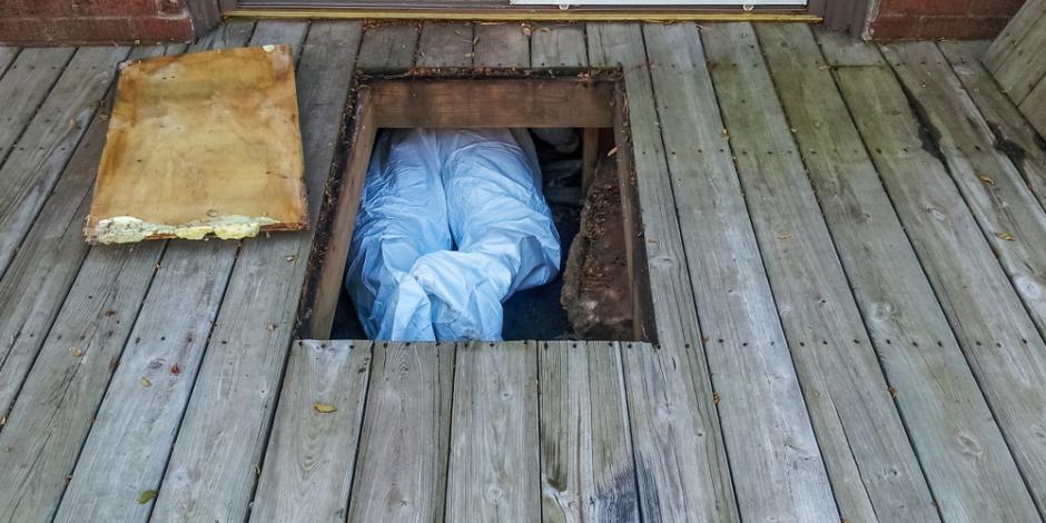 technician working in crawlspace beneath house/deck