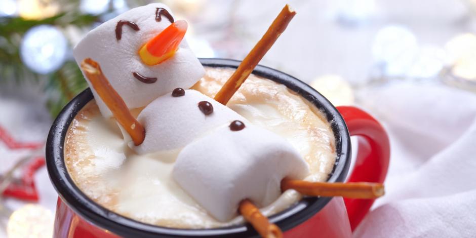 snowman made out of marshmellows in a mug of hot chocolate