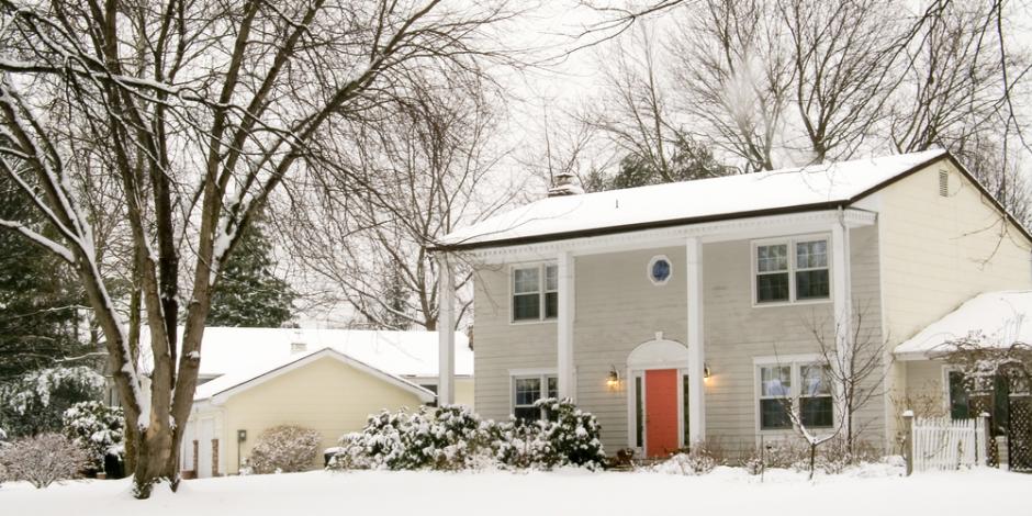 colonial house exterior during winter snow colonial house exterior during winter snow